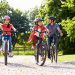 Hispanic Family On Cycle Ride In Countryside