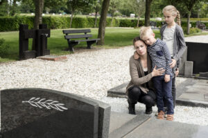 Young family visiting grave of family