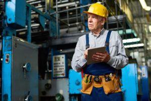 Senior Factory Worker Using Tablet