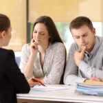 Office worker attending to a suspicious couple