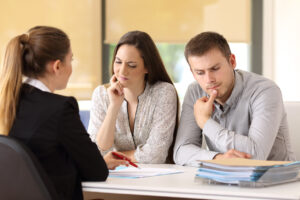 Office worker attending to a suspicious couple