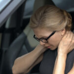 Exhausted woman feeling neck pain, sitting in automobile, spinal problem, health