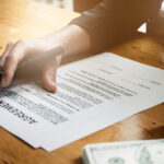 Businessman hand and contract agreement paper with customer to sign contract. Real Estate and Agreement concept. Businessman hand and contract agreement paper with customer to sign contract. Real Estate and Agreement concept.