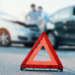 Two men reporting a car crash for insurance claim Two men reporting a car crash for insurance claim