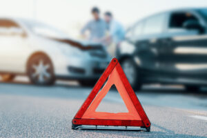 Two men reporting a car crash for insurance claim